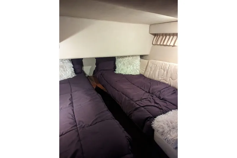 Slide: The Image of 1999 Sea Ray 400 Sedan Bridge cabin with twin beds and plush pillows. - 41