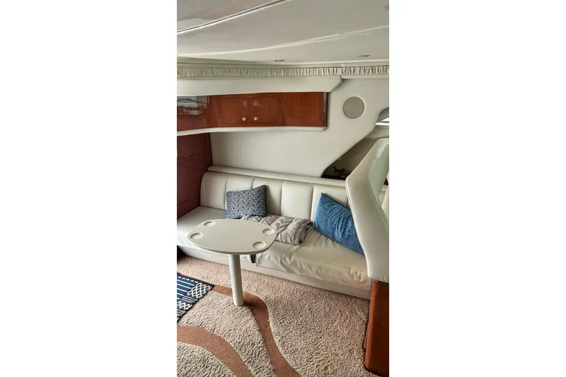 Slide: The Image of Interior of 1999 Sea Ray 400 Sedan Bridge with cozy seating and elegant decor. - 44