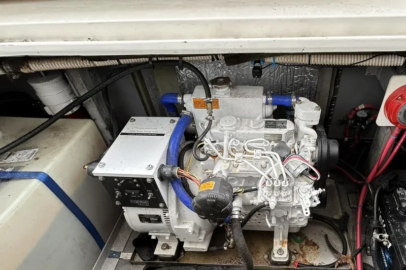 Slide: The Image of Engine compartment of a 1999 Sea Ray 400 Sedan Bridge, showcasing mechanical components and wiring. - 50