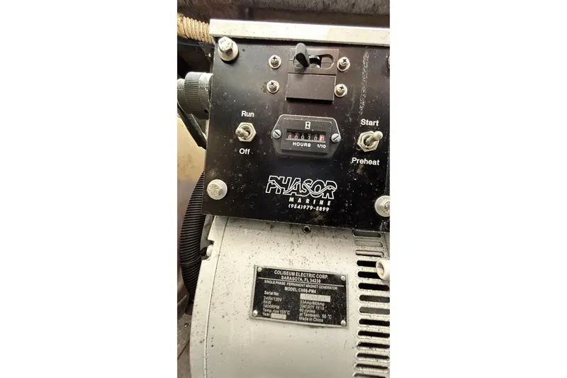Slide: The Image of Control panel of a Phasor Marine generator on a 1999 Sea Ray 400 Sedan Bridge. - 51