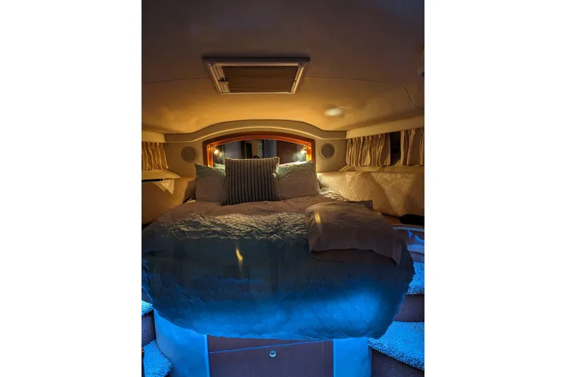 Slide: The Image of Cozy bedroom interior of 1999 Sea Ray 400 Sedan Bridge yacht with ambient lighting. - 6