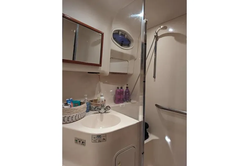 Slide: The Image of Bathroom interior of 1999 Sea Ray 400 Sedan Bridge yacht, featuring sink and shower. - 8