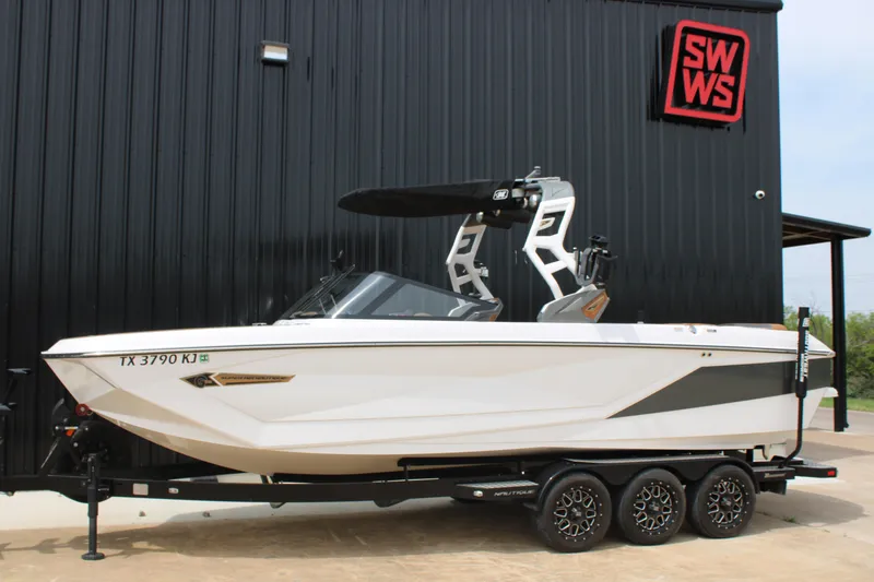 The Image of 2021 Nautique Super Air Nautique G25 boat on trailer, parked outside SWWS building. - 0
