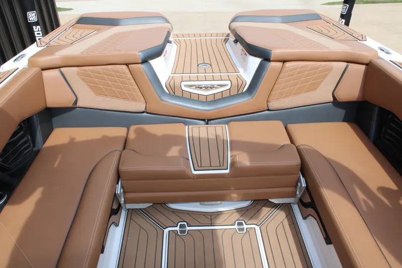 Slide: The Image of Luxurious interior of 2021 Nautique Super Air Nautique G25 boat with tan seating. - 12