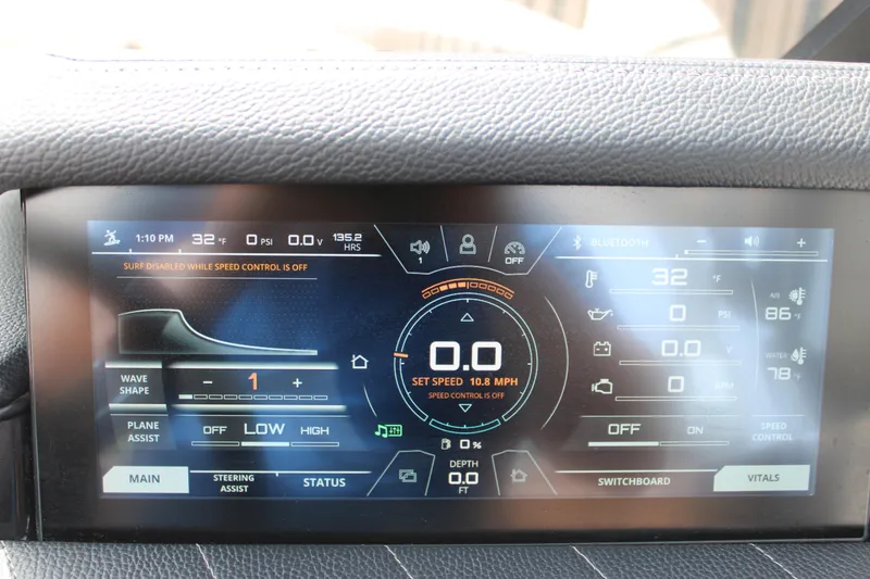 Slide: The Image of 2021 Nautique Super Air Nautique G25 dashboard display showing speed, temperature, and control settings. - 18