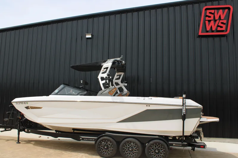 Slide: The Image of 2021 Nautique Super Air Nautique G25 boat on trailer, parked outside SWWS building. - 4