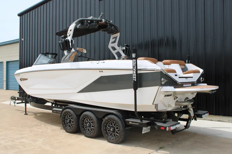 Slide: The Image of 2021 Nautique Super Air Nautique G25 boat on trailer, parked outdoors. - 5