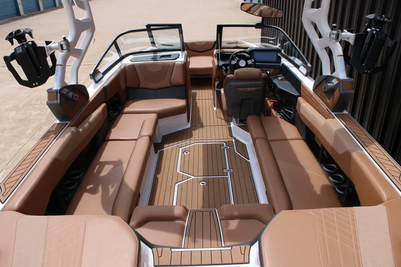 Slide: The Image of 2021 Nautique Super Air Nautique G25 interior with luxurious brown seating and sleek design. - 8