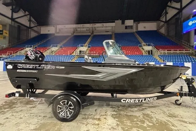 The Image of 2026 Crestliner 1850 Kodiak WT boat on display in an indoor arena setting. - 1