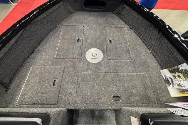 Slide: The Image of 2026 Crestliner 1850 Kodiak WT boat interior with carpeted deck and storage compartments. - 11