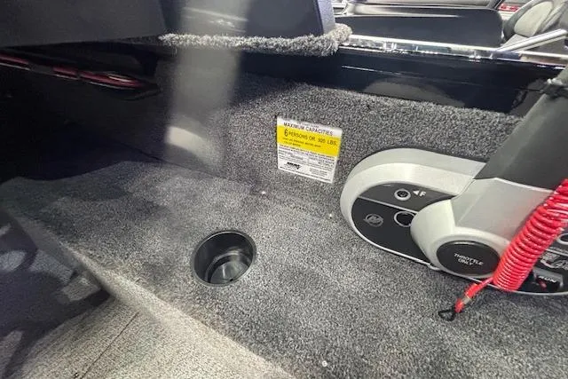 Slide: The Image of Interior view of 2026 Crestliner 1850 Kodiak WT boat, featuring carpeted flooring and control panel. - 16