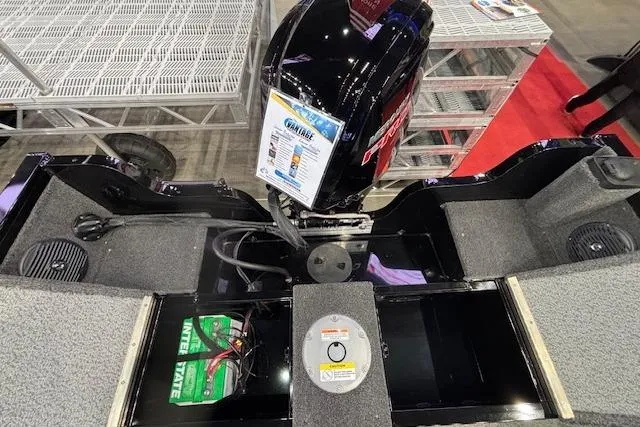 Slide: The Image of 2026 Crestliner 1850 Kodiak WT boat interior with motor and battery compartment. - 4