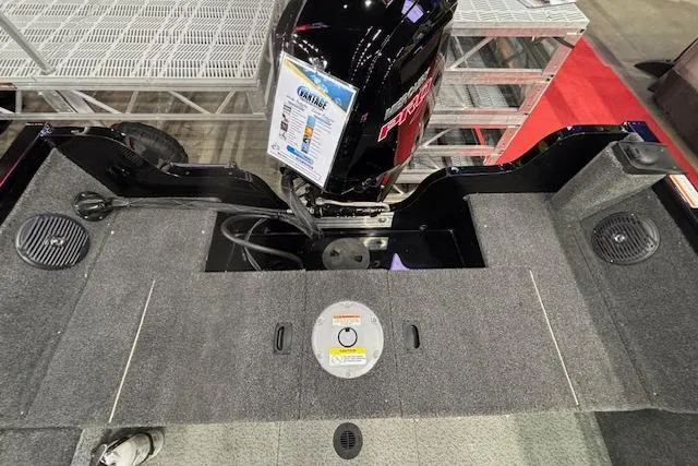 Slide: The Image of 2026 Crestliner 1850 Kodiak WT boat interior with motor and carpeted deck. - 5