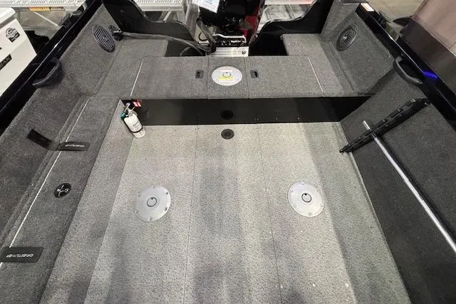 Slide: The Image of Interior view of 2026 Crestliner 1850 Kodiak WT boat, featuring spacious carpeted deck. - 6