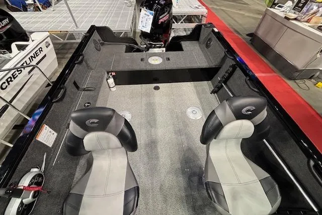 Slide: The Image of 2026 Crestliner 1850 Kodiak WT boat interior with two seats and motor display. - 7