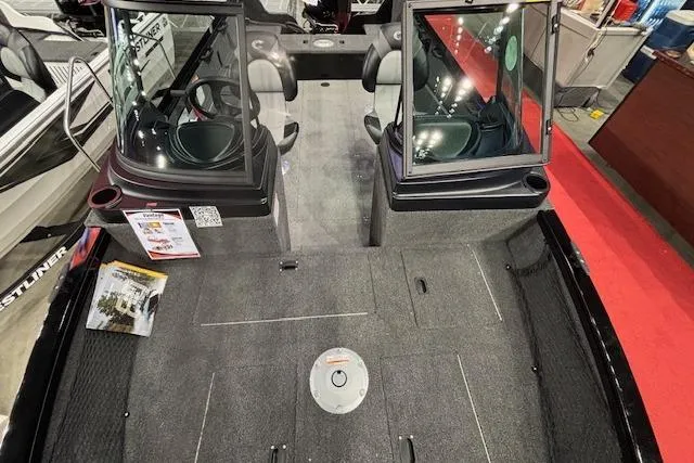 Slide: The Image of 2026 Crestliner 1850 Kodiak WT boat interior with seating and carpeted deck. - 9