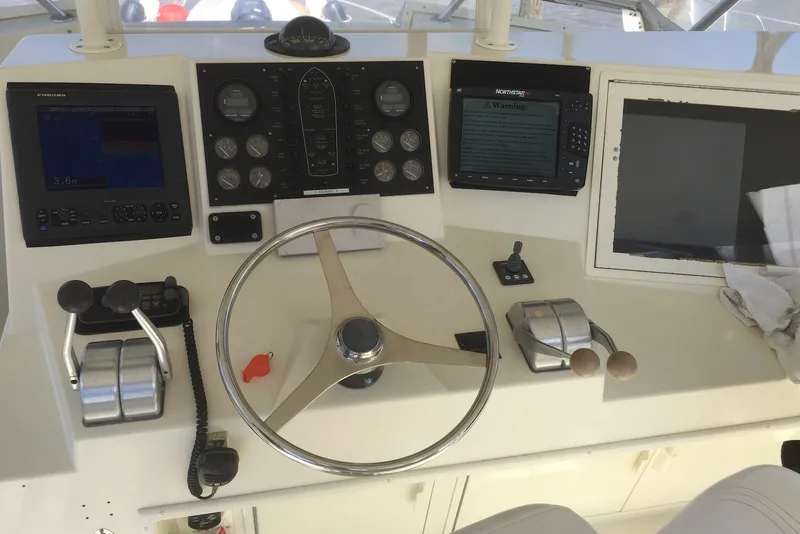 Slide: The Image of Control panel of a 1992 Viking 50 Convertible yacht with steering wheel and navigation instruments. - 2