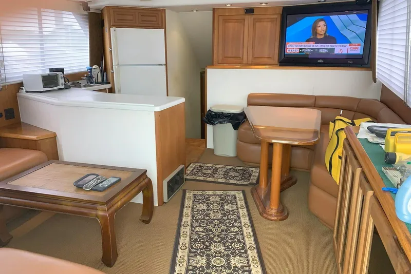 Slide: The Image of Interior of a 1992 Viking 50 Convertible yacht with cozy seating and modern amenities. - 3