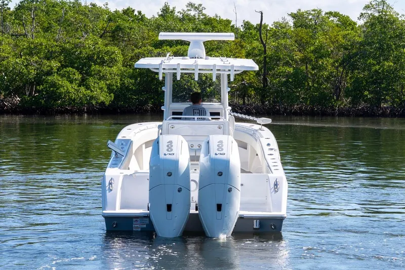 Slide: The Image of 2025 Invincible 33 Open Fisherman boat with dual engines on calm water. - 3