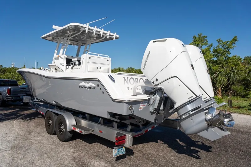 Slide: The Image of 2025 Invincible 33 Open Fisherman boat on trailer with dual Mercury engines. - 7