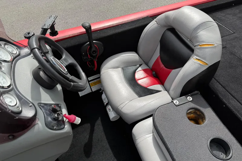 Slide: The Image of 2007 Tracker Pro Team 175 TXW boat interior with worn seat and steering wheel. - 14