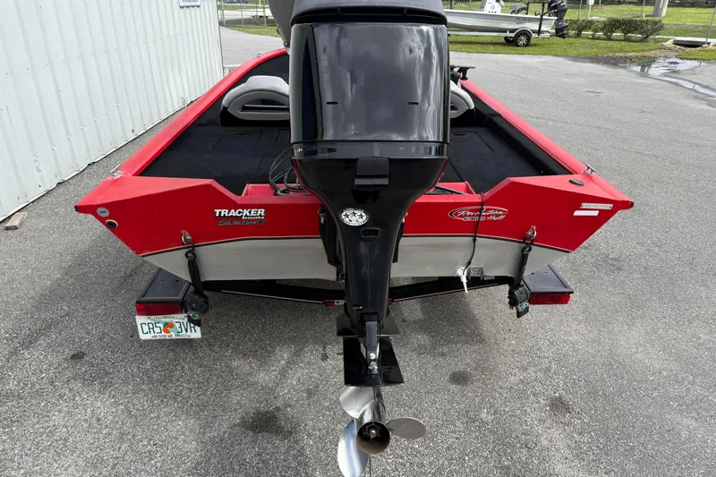 Slide: The Image of 2007 Tracker Pro Team 175 TXW boat, red exterior, parked on pavement. - 5
