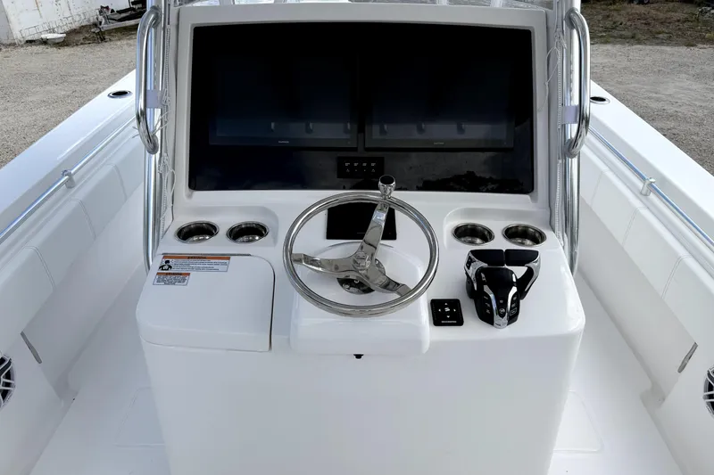 Slide: The Image of Center console of 2026 Contender 32 ST boat with steering wheel and controls. - 13