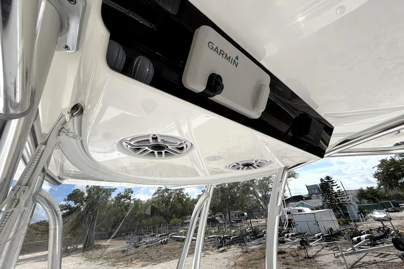 Slide: The Image of 2026 Contender 32 ST boat with Garmin electronics and speakers, docked outdoors. - 15