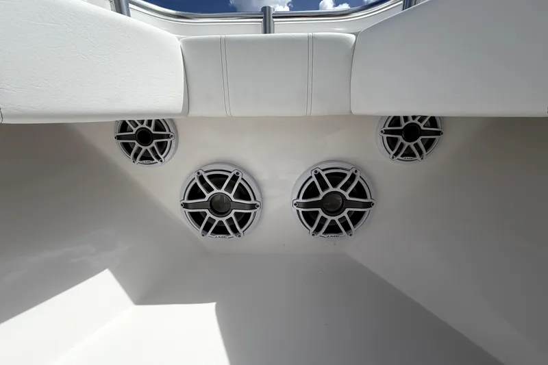 Slide: The Image of 2026 Contender 32 ST boat interior with four mounted speakers under white seating. - 18