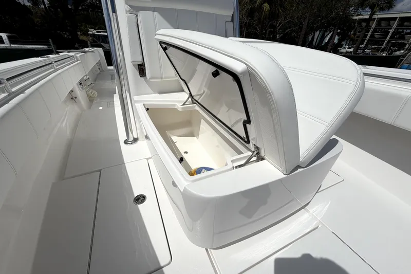 Slide: The Image of 2026 Contender 32 ST boat with open storage compartment, showcasing sleek white interior design. - 22