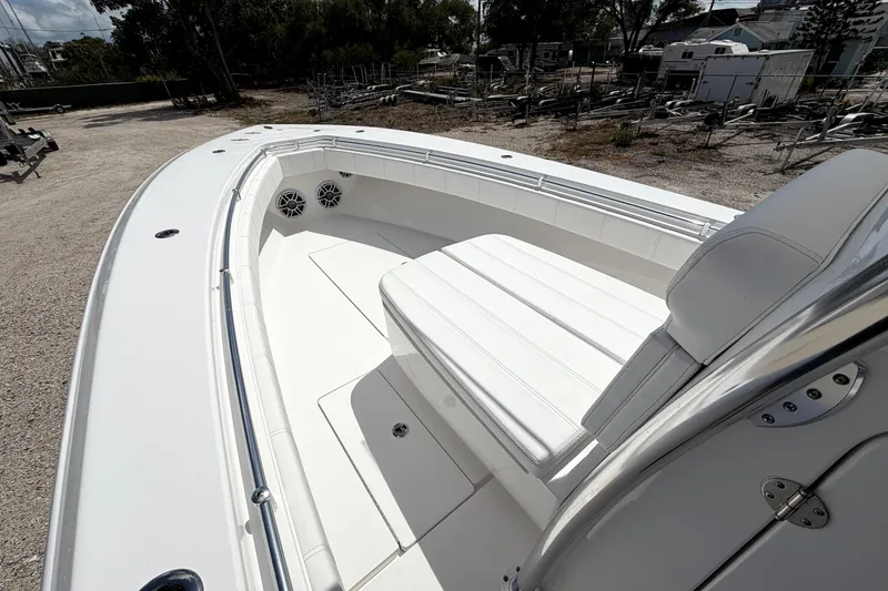 Slide: The Image of 2026 Contender 32 ST boat with spacious seating and sleek design in a marina setting. - 24