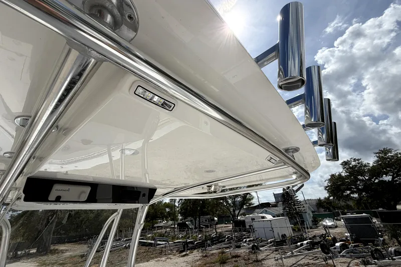 Slide: The Image of 2026 Contender 32 ST boat with stainless steel rod holders and Garmin equipment under a sunny sky. - 27
