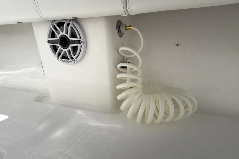Slide: The Image of Speaker and coiled hose on 2026 Contender 32 ST boat interior. - 29