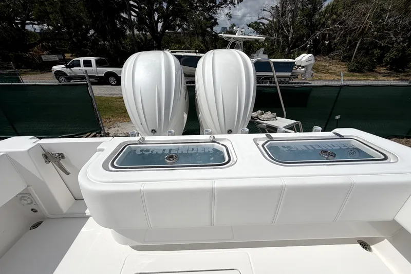 Slide: The Image of 2026 Contender 32 ST boat with dual outboard engines and livewell compartments. - 32