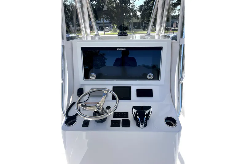 Slide: The Image of Center console of 2026 Contender 32 ST boat with steering wheel and controls. - 6