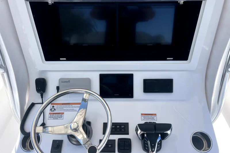Slide: The Image of Helm of 2026 Contender 32 ST boat with steering wheel and navigation displays. - 7