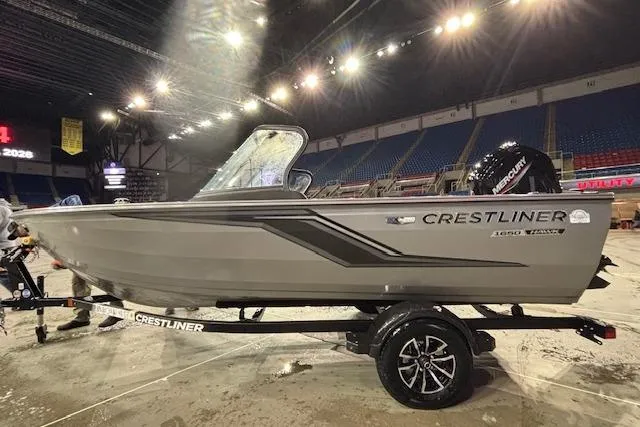 The Image of 2026 Crestliner 1650 Hawk boat on display in an indoor arena setting. - 1