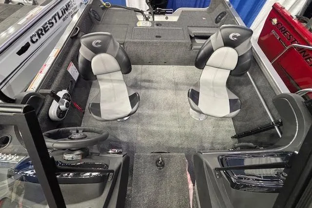 Slide: The Image of 2026 Crestliner 1650 Hawk boat interior with two seats and steering console. - 10