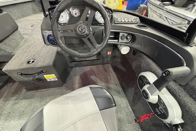 Slide: The Image of 2026 Crestliner 1650 Hawk boat cockpit with steering wheel and control panel. - 18