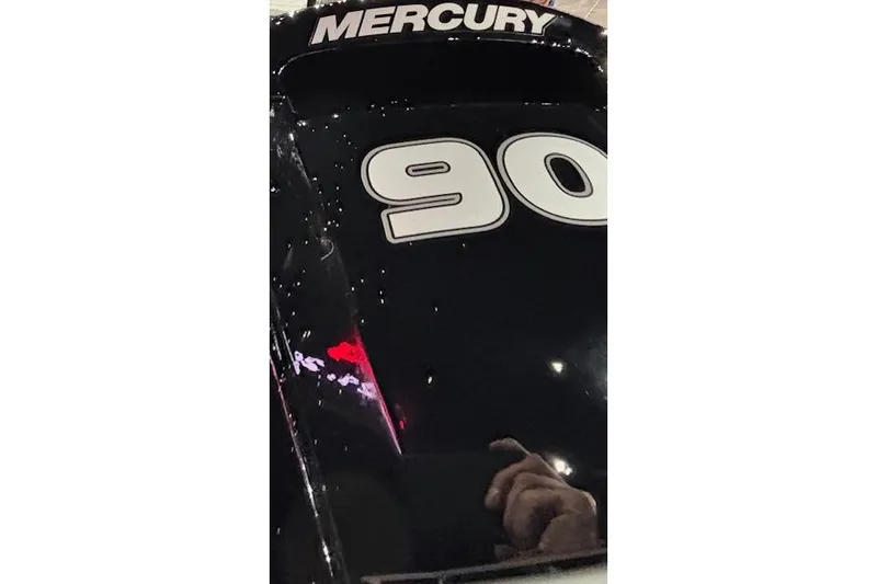 Slide: The Image of 2026 Crestliner 1650 Hawk with Mercury 90 engine, black finish, close-up view. - 6