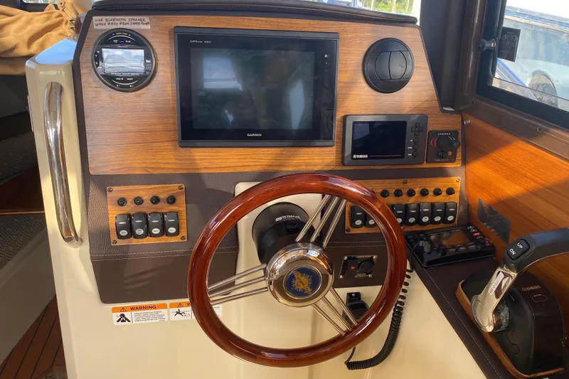 Slide: The Image of 2020 Ranger Tugs R-23 helm with Garmin display and Yamaha controls. - 3