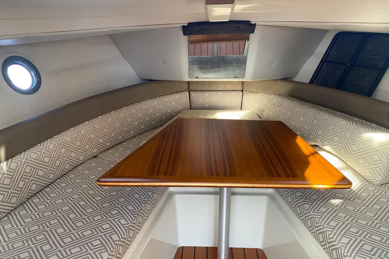 Slide: The Image of Interior of 2020 Ranger Tugs R-23 boat with wooden table and patterned seating. - 4