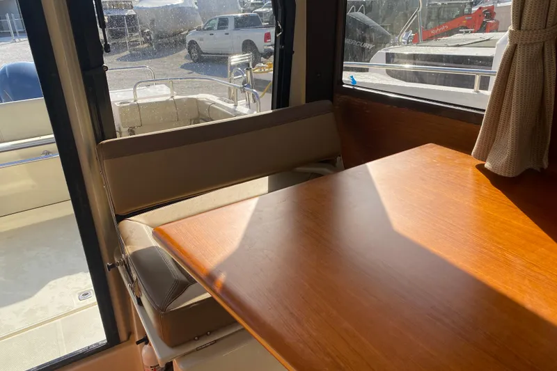 Slide: The Image of Interior of 2020 Ranger Tugs R-23 boat with wooden table and seating. - 5