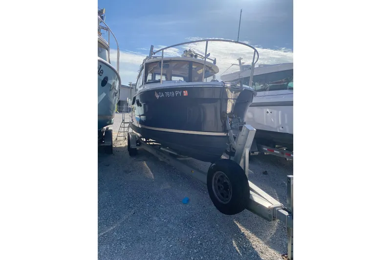 Slide: The Image of 2020 Ranger Tugs R-23 boat on trailer, parked outdoors under clear sky. - 9