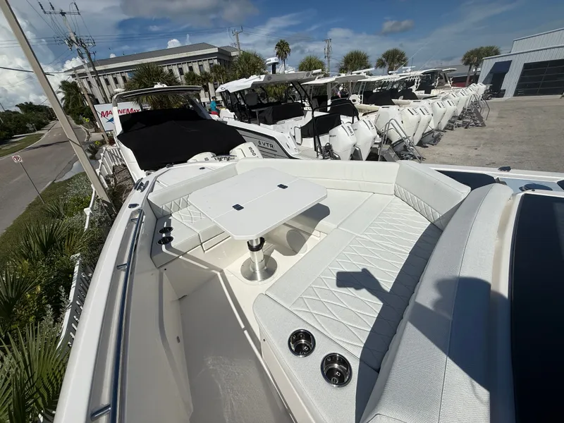 Slide: The Image of The image shows the bow of a Saxdor 400 GTC with white upholstery and a table. - 9