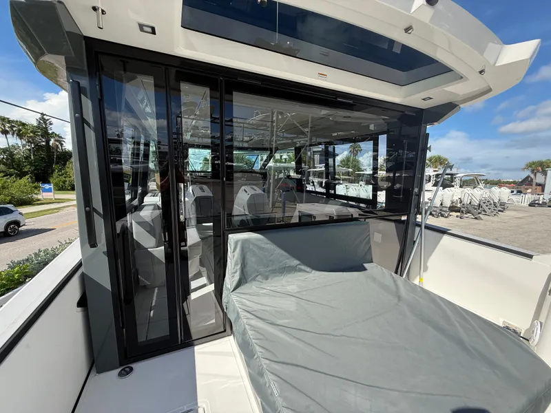 Slide: The Image of The image shows a modern boat with a covered cabin and an outdoor lounging area. - 34