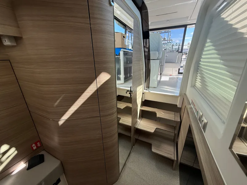 Slide: The Image of Interior of a 2027 Saxdor 400 GTC with wood paneling and stairs leading to an outdoor deck. - 17
