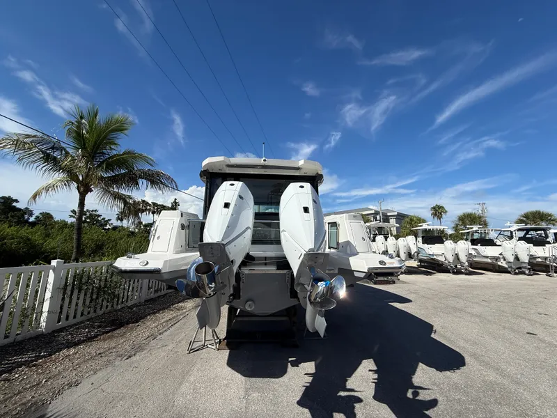 Slide: The Image of The image shows a 2027 Saxdor 400 GTC boat with twin outboard engines in a parking area. - 5