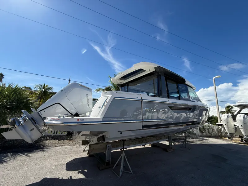 Slide: The Image of The image shows a Saxdor 400 GTC boat from 2027 on a stand under a blue sky. - 3