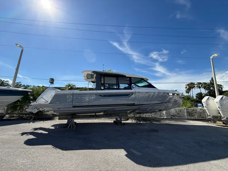 Slide: The Image of A 2027 Saxdor 400 GTC boat is parked on a lot under a clear sky. - 2